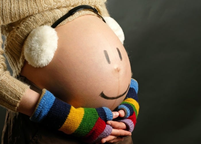 silly baby bump picture idea with earmuffs fin