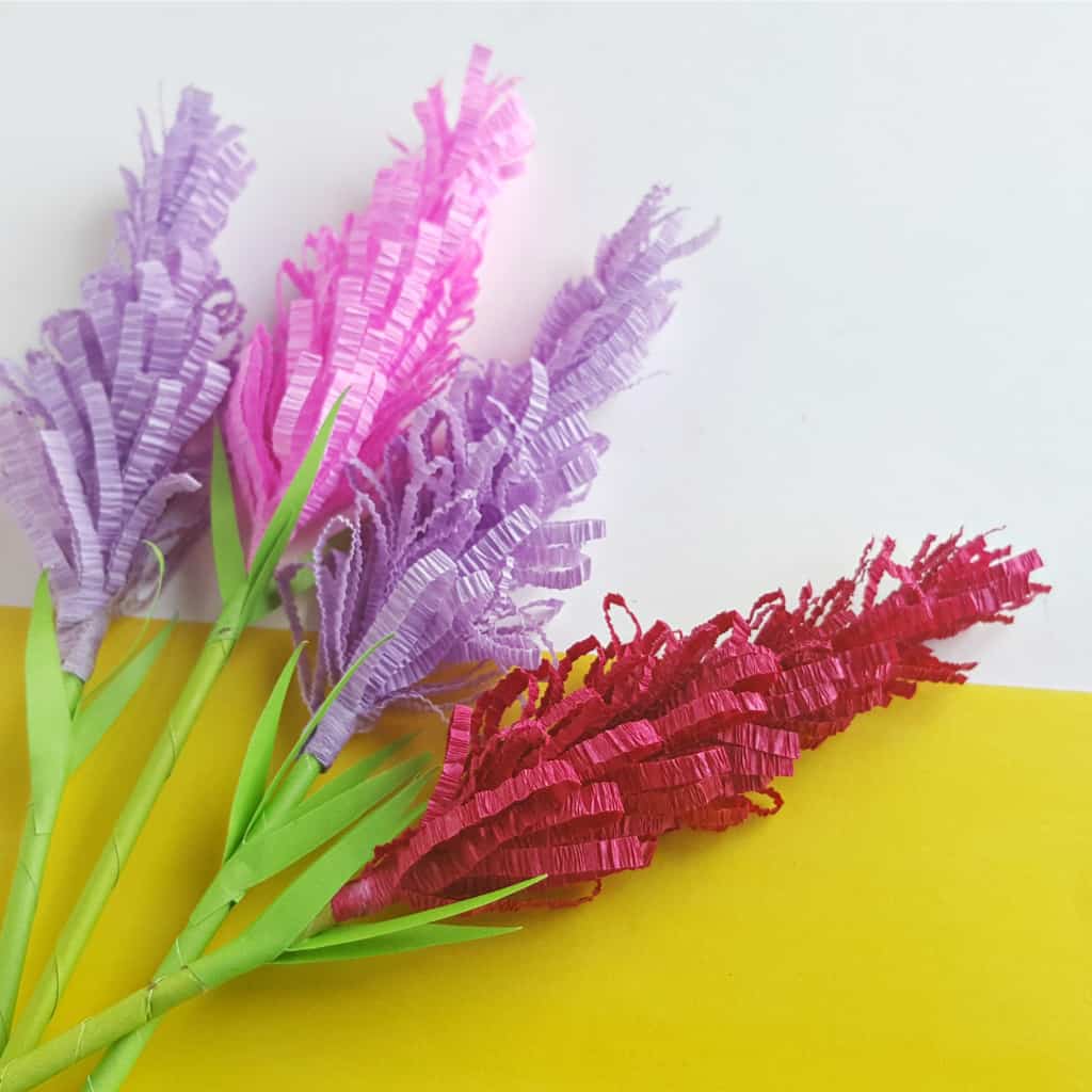 Bored with a corner of your bathroom? I was. So I totally made some DIY Paper Lavender Flowers. You can call them paper flowers. Or lavender paper flowers. Or anything--and you can make them in any color. Just make them, pot them and put them in your boring bathroom corner. Done. #nerdymammablog #craft #diy #papercraft #paperflower #paperflowers #craftflowers #easy #papercrafts 