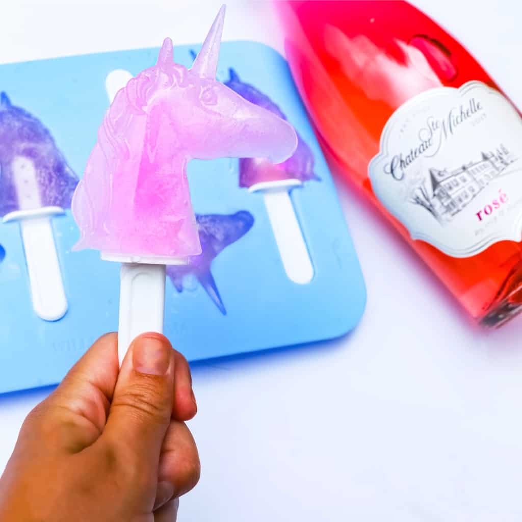 A special friend, a special bottle of adult beverage, and a unicorn popsicle mold--this is recipe for Rosé Unicorn Popsicles is so easy, but so awesome. You seriously need these for your next adult backyard fest. Seriously. #nerdymammablog #unicorn #adultbeverage #rose #popsicle #adultpopsicle #alcoholpopsicle #unicornpopsicle