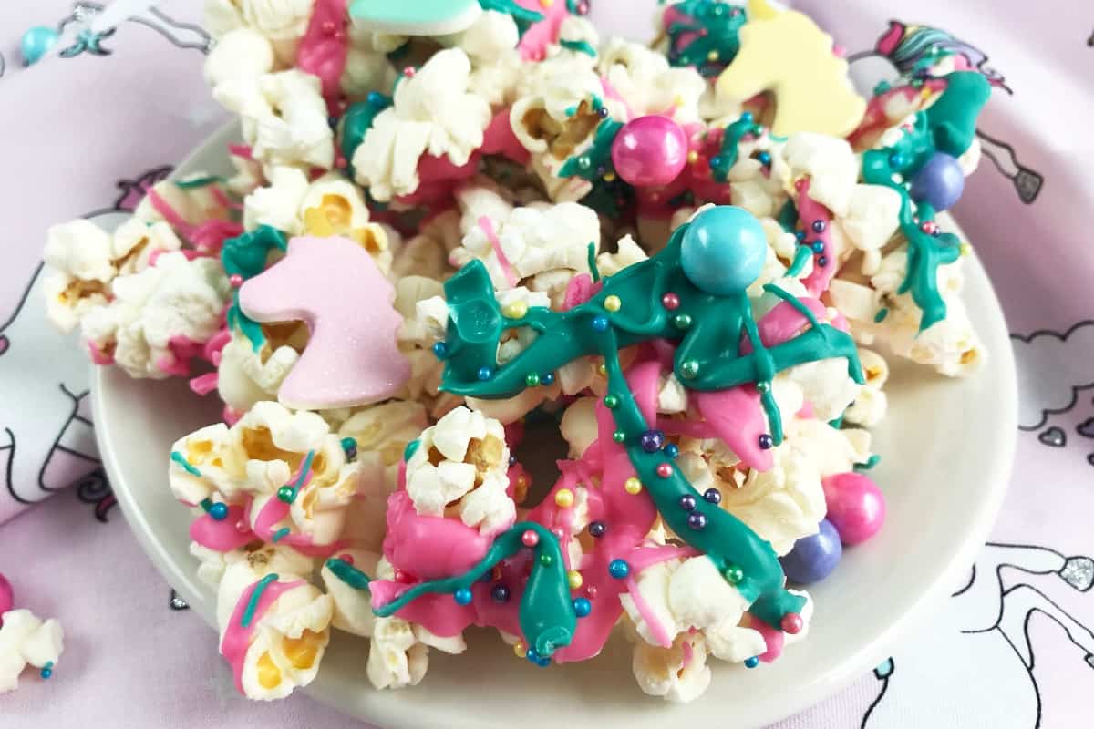 Snack time needs be boring no more! Gimme about 5 minutes and you'll have an epic Unicorn Candy Popcorn to make the kids giggle and bring their afternoon snack into the "fun" zone. #nerdymammablog #unicorn #popcorn #unicornpopcorn #snack #recipe