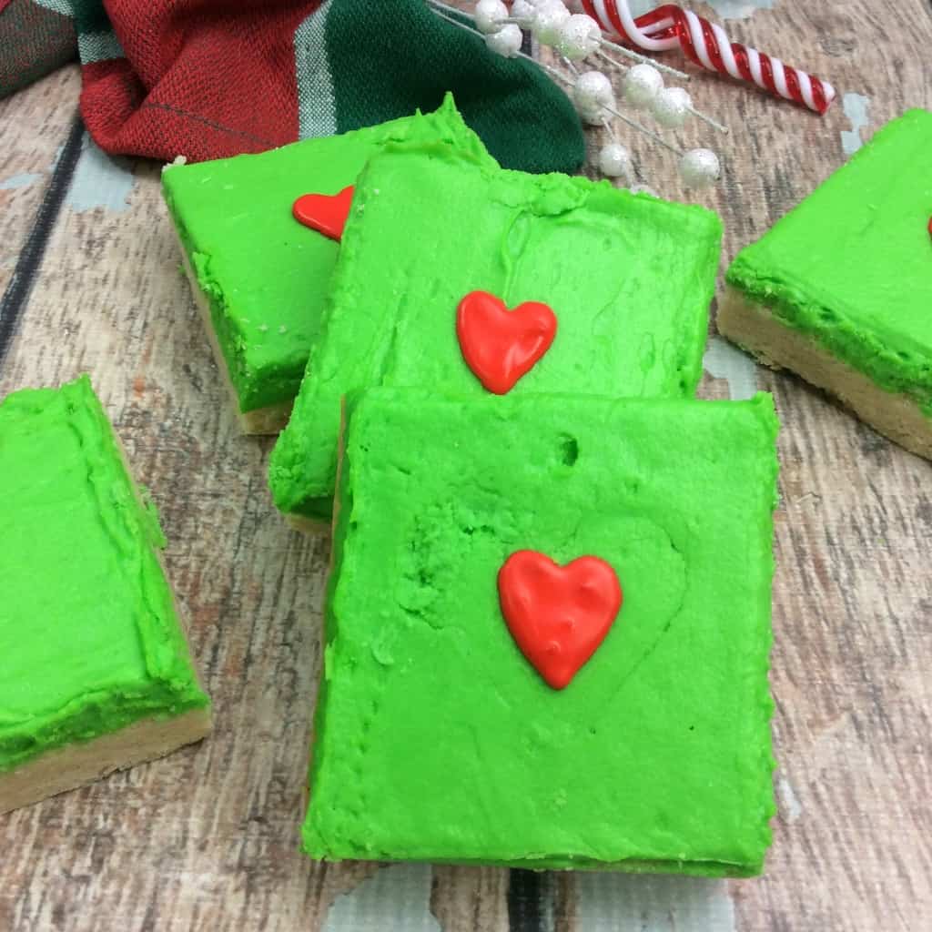 This super easy recipe for Grinch Sugar Cookie Bars is a treat you can take to school parties, have a little Grinch-watching party...anything. They're little perfect treats just for me--uh, I mean perfect treats for anyone. #nerdymammablog #grinch