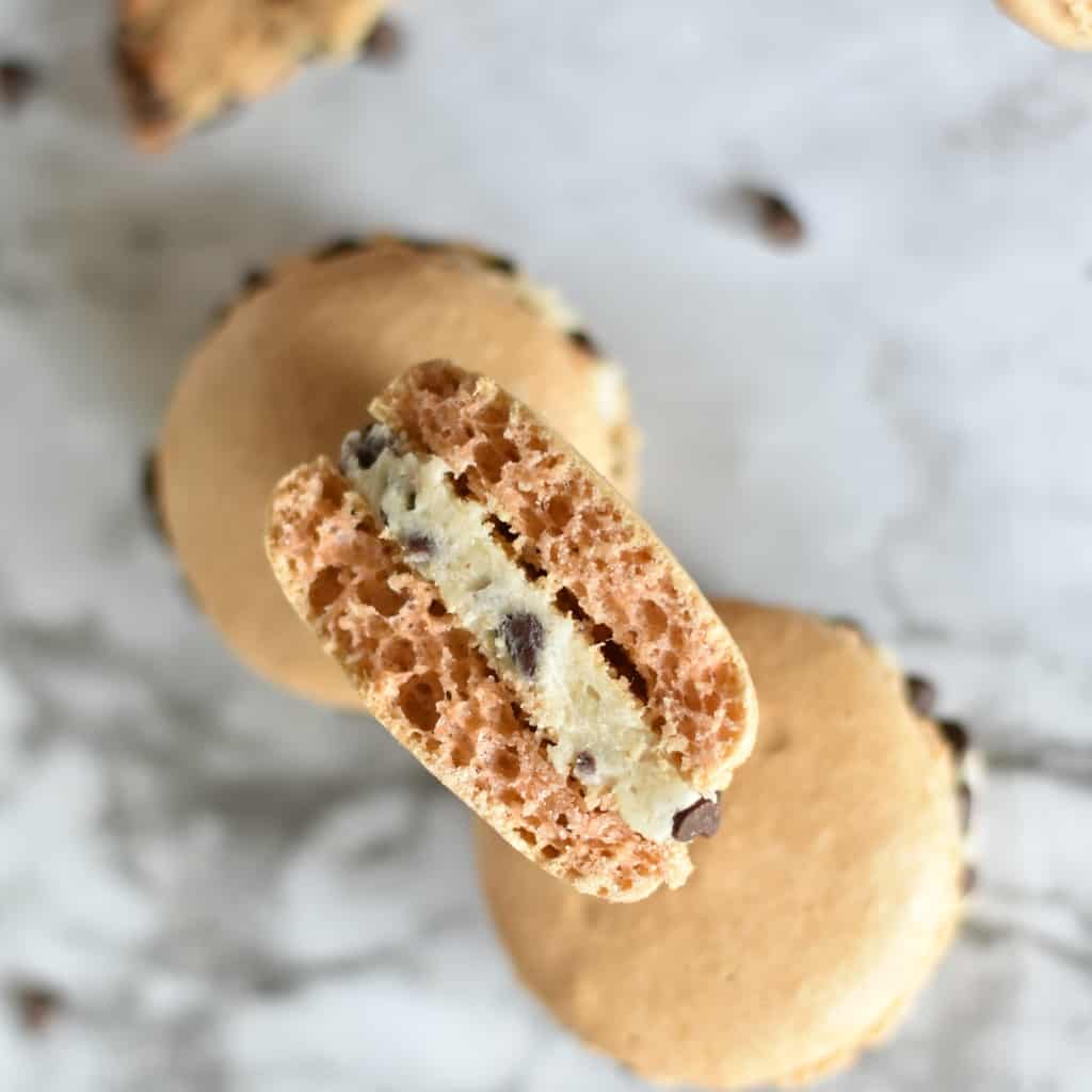 When you want a pick-me-up, there's nothing like having a bit of cookie dough...and these Cookie Dough Macarons are like the week-long version of that perfect feeling of happy. #macaron #frenchmacaron #macaroncookies #macaronrecipe #cookiedough #cookie #cookiedoughmacaron #nerdymammablog 
