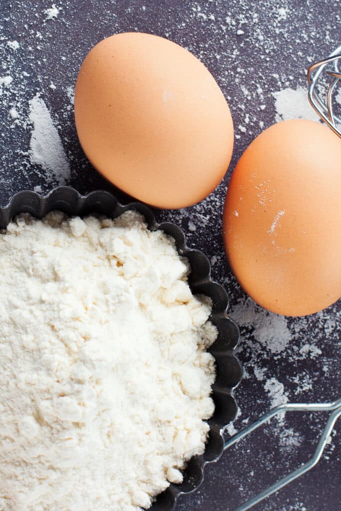 overhead view of pile of flour and two eggs