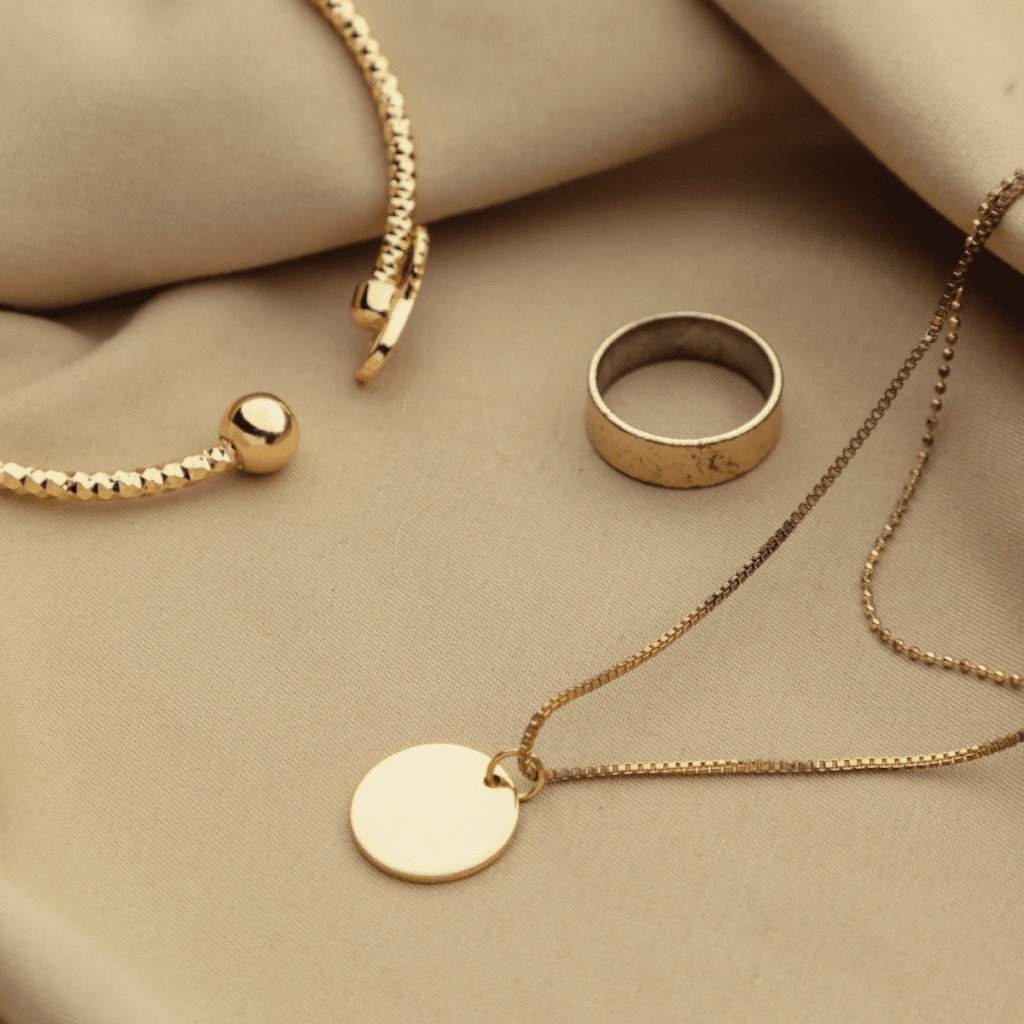 A photo of a set of gold accessories in a brown background