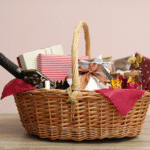 Wicker gift basket with bottle of wine on wooden table