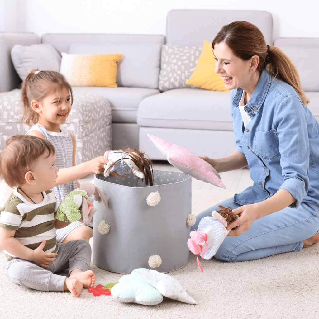 Housewife and children picking up toys after playing at home