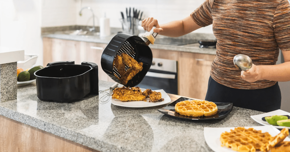 Woman serving fried chicken with air fryer waffles