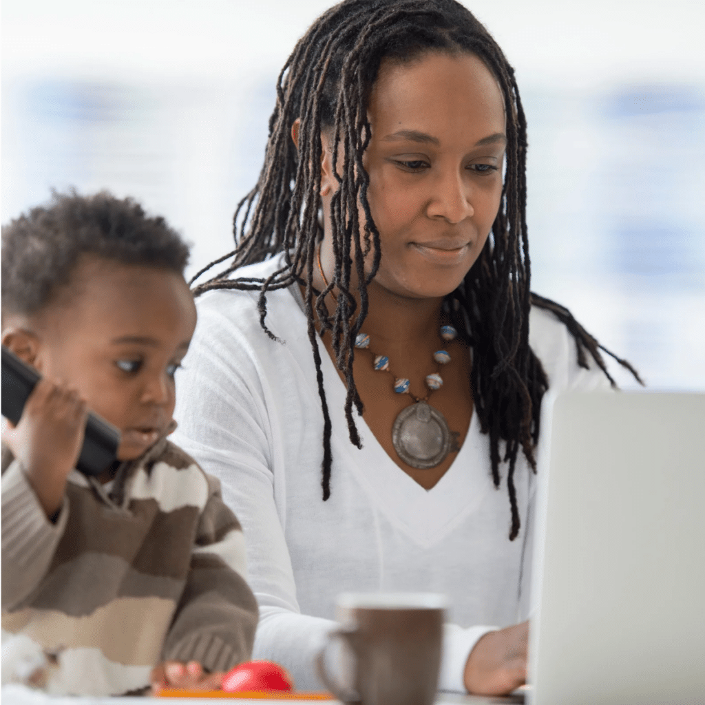 A single mother is answering emails and talking calls for her new start up business.