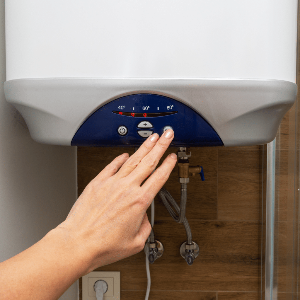 a close up picture of a water heater with a hand