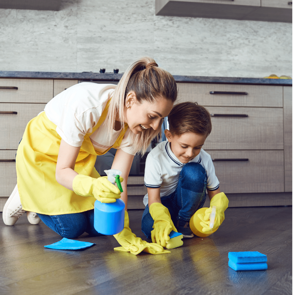 Mother teaching her son how to clean the floors at home