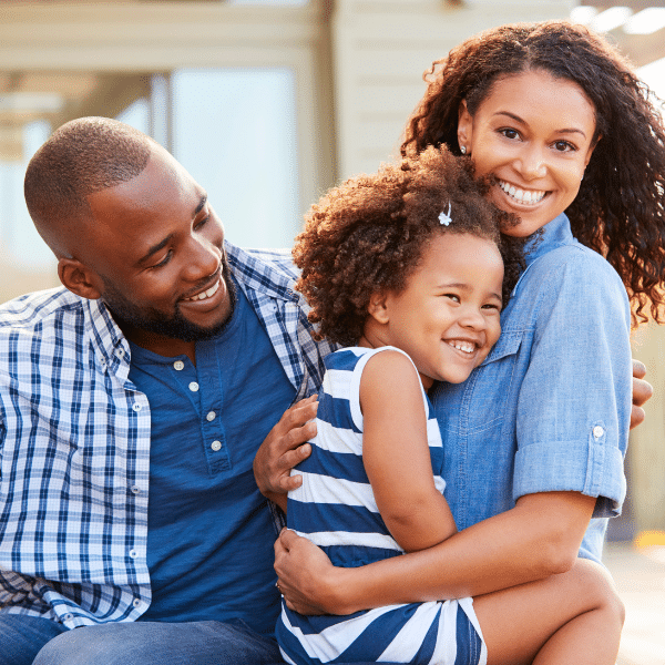 A happy family shares a quiet moment of connection, showing how parents can create calm amid daily chaos.