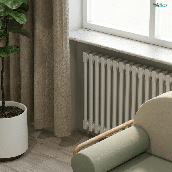 Modern vertical home radiator installed beneath a window beside curtains and a cozy chair, showing stylish heating for living spaces.