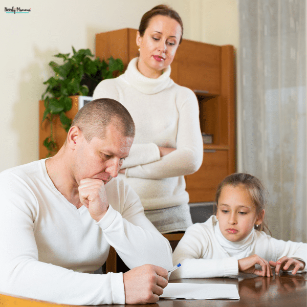 Family sitting at a table looking concerned over paperwork, showing emotional stress and the need for support after a difficult situation.