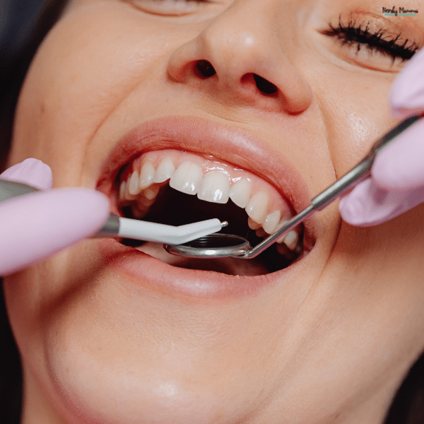 Dental professional examining teeth with tools, showing routine care that helps maintain a healthy and confident smile.