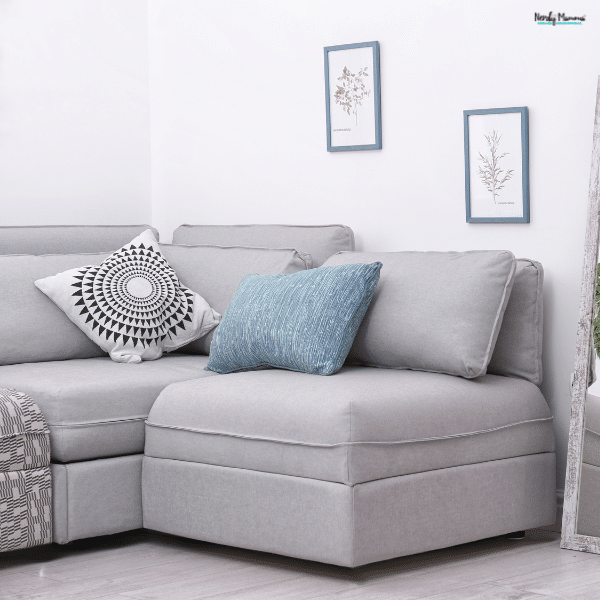 Clean and organized sectional sofa with pillows and simple decor, showing a living room that stays neat and put together for busy mom life.