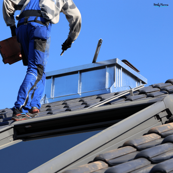 Worker repairing a rooftop vent on a house, highlighting maintenance issues that can cause hidden stress in the home.