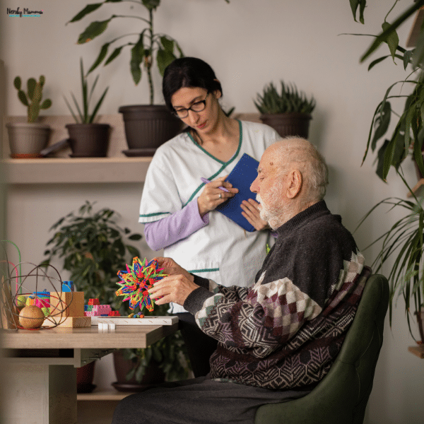 Caregiver assisting an elderly man with a hands-on activity at home, showing personalized home health care support for aging parents.