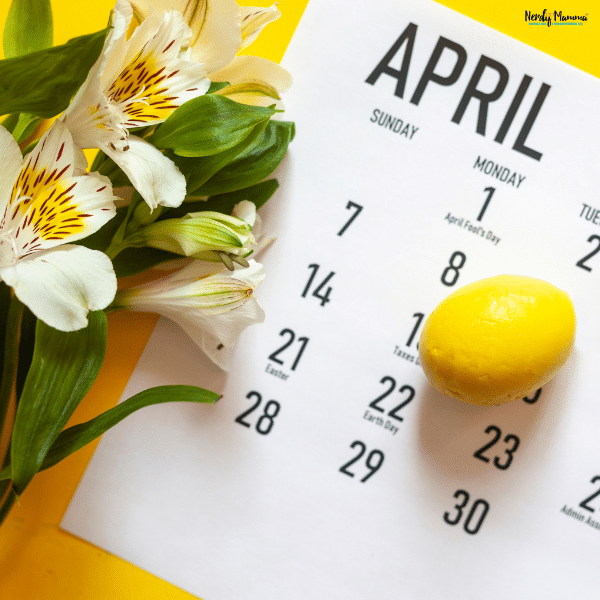 Spring flowers beside a printed calendar page showing a personalized family photo calendar DIY project for home organization.