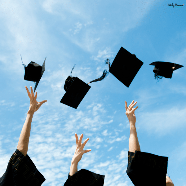 Graduates tossing caps into the air, symbolizing achievement, new beginnings, and the start of financial independence after graduation.