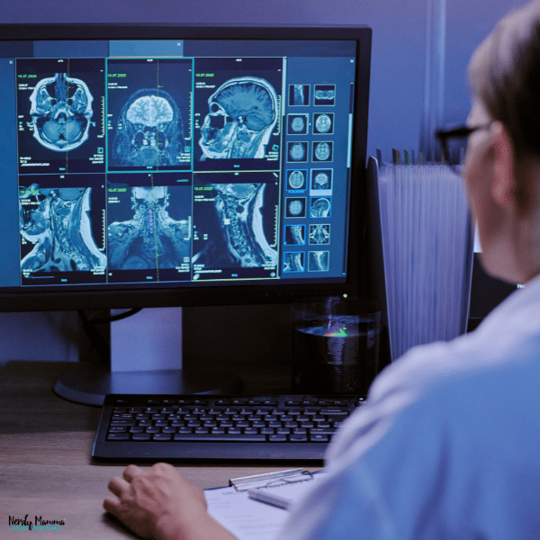 Mom studying medical imaging scans on a computer as part of a career training program for returning to the workforce.