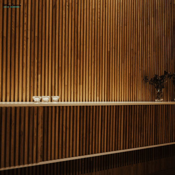 Modern interior with dark wood vertical slat panels creating texture and warmth in a stylish living space.