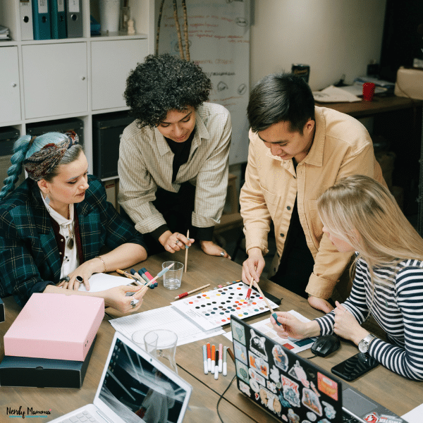 Small business team brainstorming creative branding and marketing ideas during a collaborative office meeting.