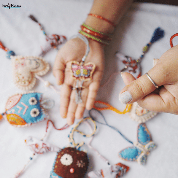 Handmade craft accessories displayed on a table while a small business owner organizes colorful artisan products for business growth.