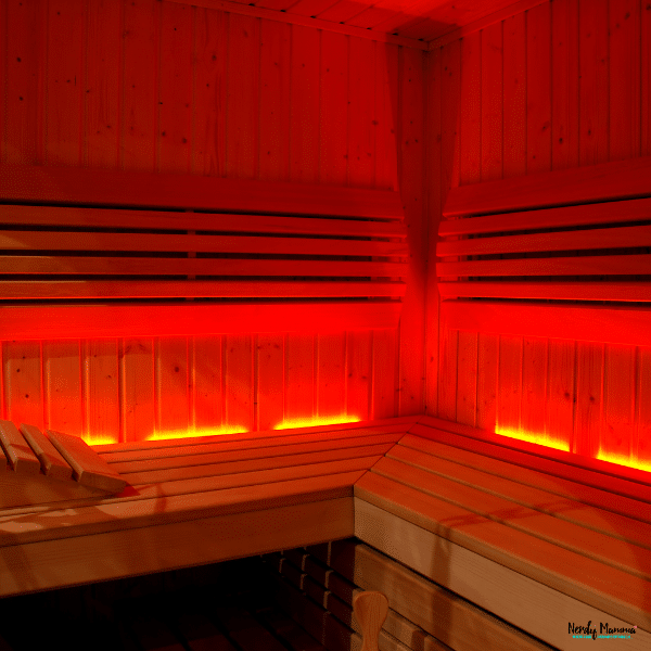 Wooden infrared sauna with glowing red heat panels designed for deep heat therapy, relaxation, and muscle recovery.