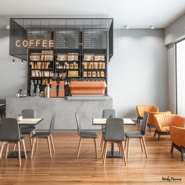 Modern coffee shop seating with cozy tables and lounge chairs designed to create comfortable shared spaces for conversation and relaxation.