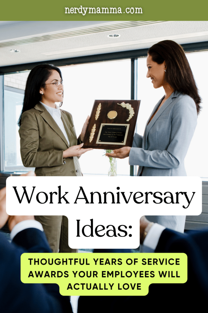 Two employees exchanging a professional appreciation plaque during a workplace recognition event focused on employee service milestones.