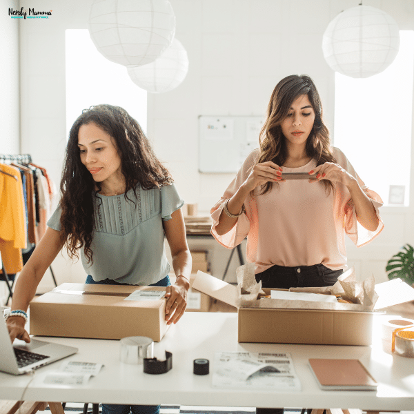 Small business owners packaging customer orders at a workspace, highlighting professional service and reliable order fulfillment.