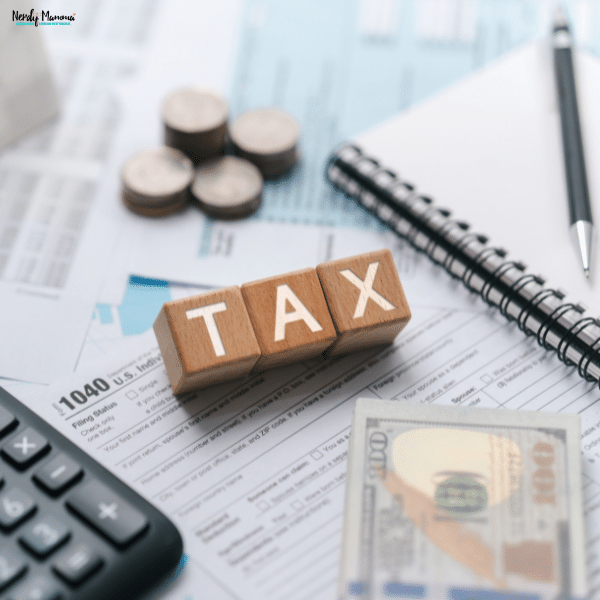 Financial records, calculator, cash, and tax paperwork arranged to support rental property expense tracking and landlord budgeting.