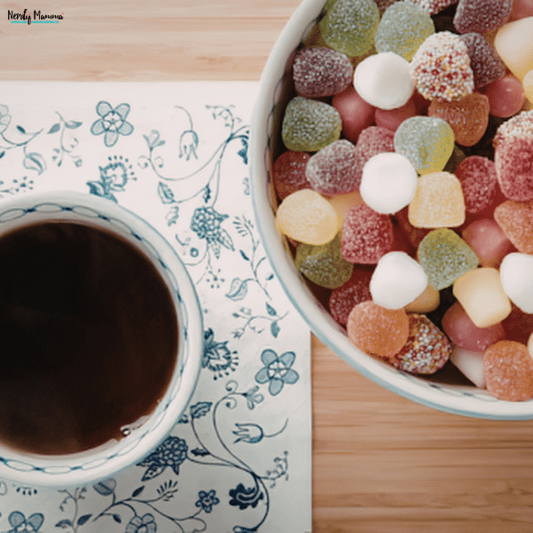 Bowl of caffeine gummies beside a cup of coffee, comparing popular caffeine sources used to support focus and alertness.