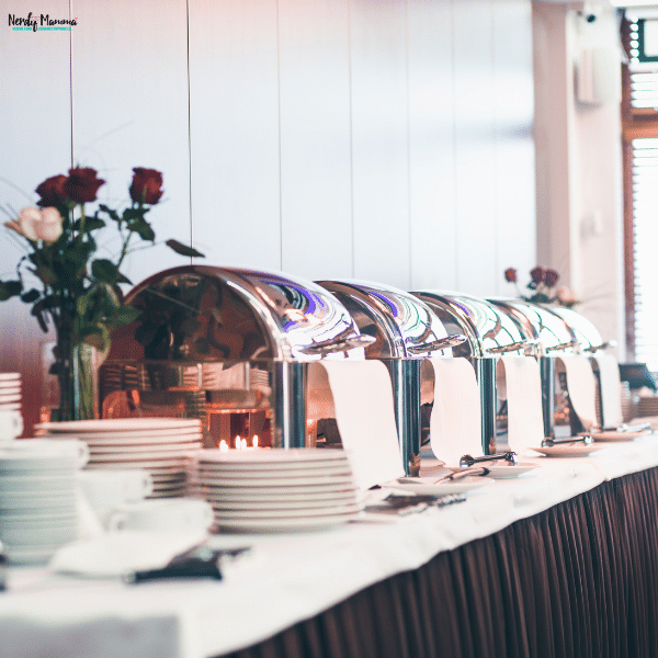 Polished chafing dishes lined up for a catering event, providing consistent food temperature and elegant service.