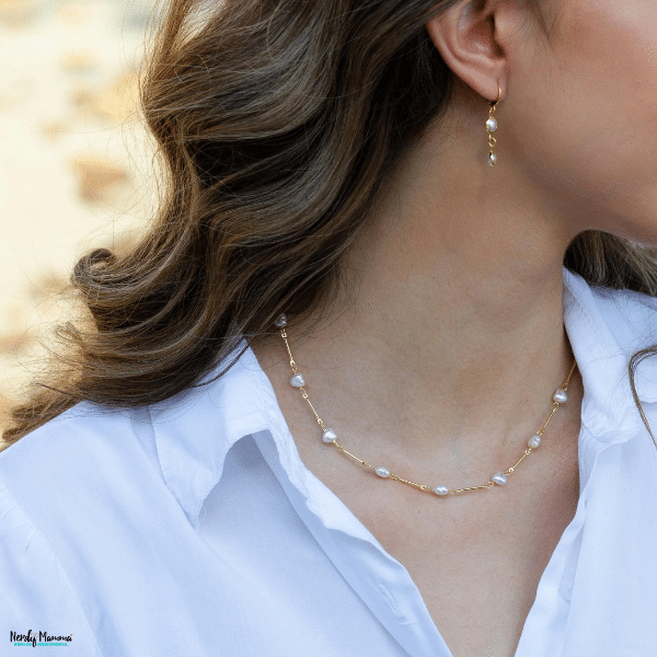 Delicate jewelry worn with everyday clothing, highlighting meaningful accessories chosen for lasting value and personal significance.