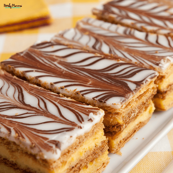 Layered pastry bars with decorative icing and rich filling, showcasing nostalgic baked desserts that remain popular across generations.