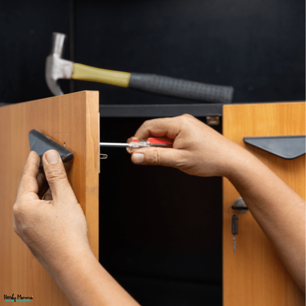 Person installing a cabinet handle, highlighting how the right cabinet handle finish can improve both style and everyday function.