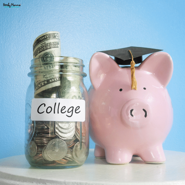 A savings jar filled with cash sits beside a piggy bank wearing a graduation cap, representing saving money for future education expenses.