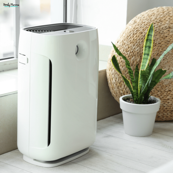 A modern air purifier sits near a window, helping improve indoor air quality and create a healthier home environment.