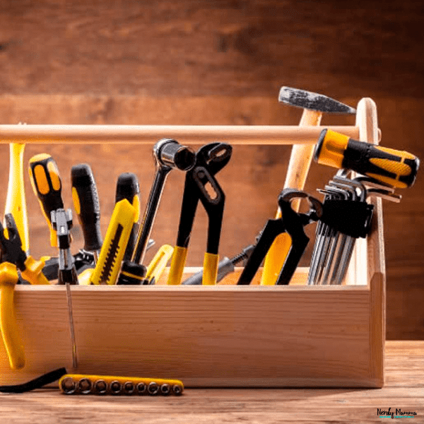 Wooden portable toolbox filled with essential hand tools for DIY home repairs and routine household maintenance tasks.
