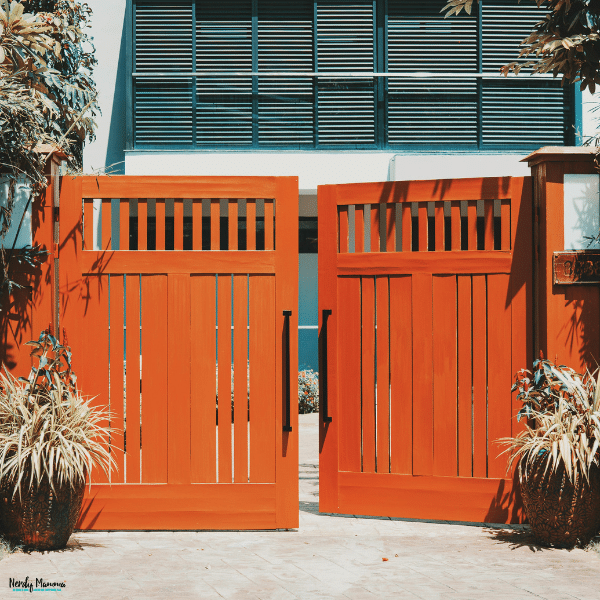 A modern wooden driveway gate provides secure access while adding privacy and curb appeal to a residential property.