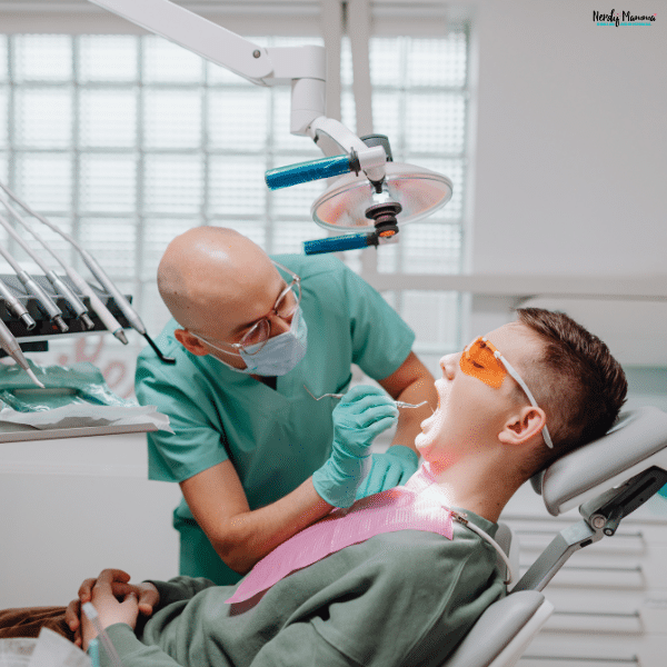 Dentist performing a routine dental examination on a patient to help maintain healthy teeth and catch oral health problems early.