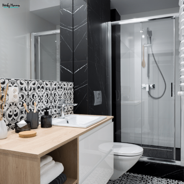 Modern bathroom with a walk-in shower, stylish vanity, and organized storage, showing a clean and refreshed space after simple updates.