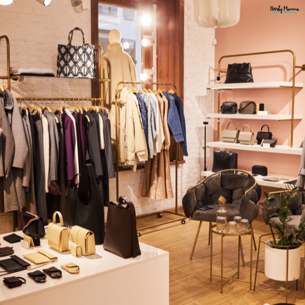 A stylish clothing boutique displays neatly arranged apparel, handbags, and accessories for shoppers seeking quality fashion.