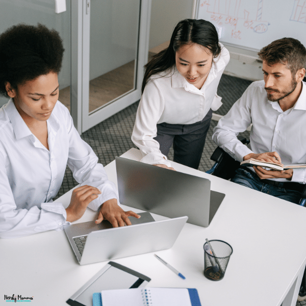 Business professionals collaborating on projects, highlighting teamwork, leadership, and management skills developed through a business administration degree.