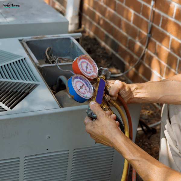 Routine HVAC maintenance in progress as a technician checks system pressure to improve performance and prevent costly repairs.