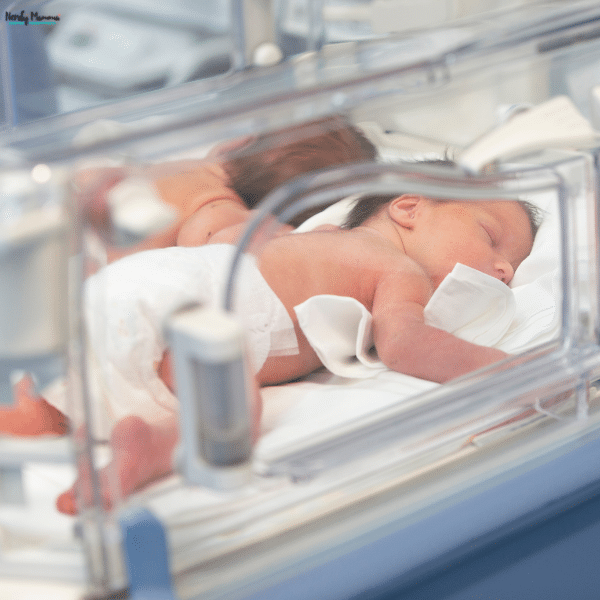 A newborn rests in a hospital neonatal intensive care unit, representing the serious medical conditions that can lead to an NEC lawsuit.