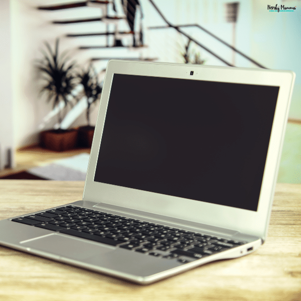 Used laptop resting on a table, representing the first step of preparing a device for safe donation after backing up and removing personal data.