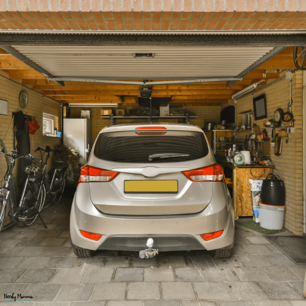 Vehicle parked inside a home garage, representing a non-running car waiting for repair, sale, or removal.