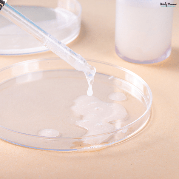 A skincare serum being dispensed from a dropper into a dish, highlighting ceramide skincare for hydration and skin barrier support.